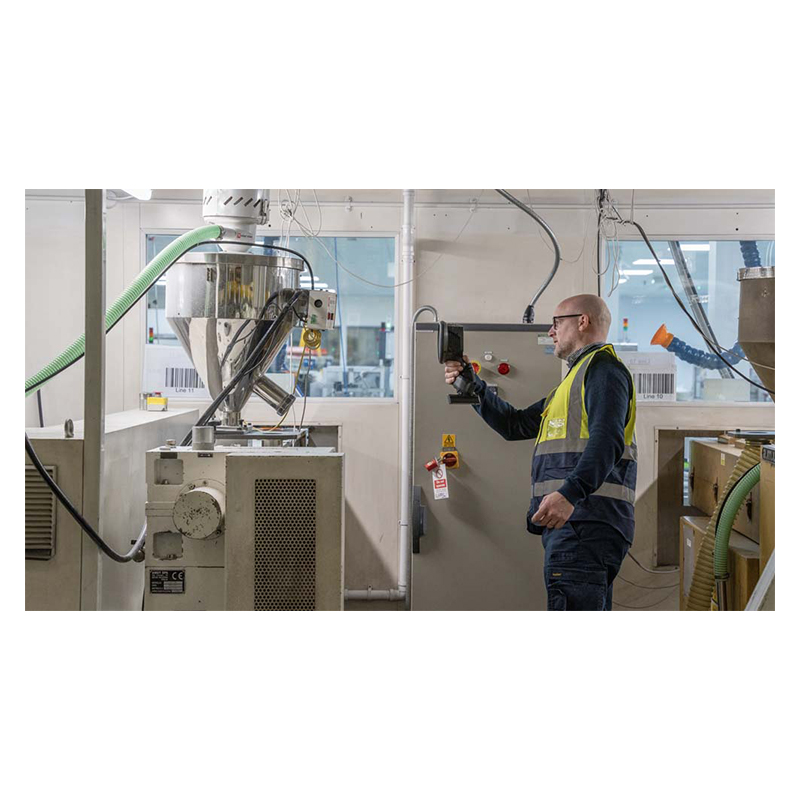A man is using the FLIR Si1-LD Acoustic Camera it inspect mechanical equipment. 